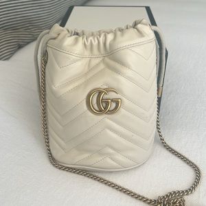 Gucci calfskin mini matelasse GG Marmont 2.0 bucket bag in white.